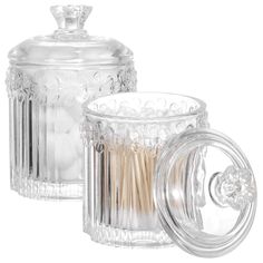 two clear glass jars with toothpicks inside one is empty and the other has a lid