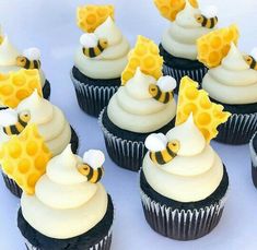 cupcakes with white frosting and yellow decorations