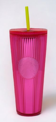 a pink glass with a yellow straw in it