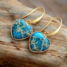 Gold Blue Impression Jasper Heart Earrings placed onto a wooden log Heart Energy, Imperial Jasper, Jasper Earrings, Turquoise Heart, Crystal Dangle Earrings, Heart Dangle Earrings, Heart Gemstone, Heart Drop Earrings, 7 Chakras