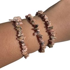 This listing is for one (1) rhodonite chip bracelet. These are stock photos in which you will be hand selected a bracelet. These are one size: "one size fits all" These are best suited for wrists measuring 5.5-7 inches in diameter. They do stretch quite a bit past that as well (if needed). (I have quite small wrists and they fit me fine, they are not too loose though; my wrists are shown in the picture). They are strung on elastic string in order to fit almost any wrist size! These bracelets are very stretchy!  Chip Style: these are tumbled, smooth stones but have an organic shape.  Stone size: 5-8mm Chakra: Heart Metaphysical: It supports self-determination and releases grief from the emotional body. It assists in maintaining optimum health.  Each order is packaged with love and care. If Chip Bracelet, Emotional Body, Pink And Black, Organic Shapes, Arm Band, One Size Fits All, Peru, Chakra, Light Pink