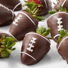 chocolate covered strawberries are arranged on a white surface