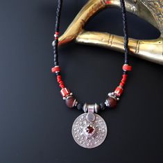 Old Sterling Silver Pendant Necklace. Step into the world of cultural fusion with this fabulous pendant from Pakistan, imbued with influences from China, Asia, and Indian traditions. Adorned with recycled glass, old Venetian glass, lava, and stainless steel, this one-of-a-kind piece showcases a captivating blend of red and black hues accented with silver details. Designed and crafted by Mystic Pieces, this unique Bohemian accessory effortlessly transitions from casual to formal settings, making it a versatile addition to your jewelry collection. Elevate your style with this necklace that exudes individuality. SEE BRACELETS IN PHOTO: *SIZE* Length is 17 to 18 inches Pendant is 1.25" by 1.50" *CARE FOR YOUR NECKLACE* Remove necklace when bathing, swimming, exercising or sleeping.  Let lotion One Of A Kind Red Jewelry For Festivals, Artisan Red Jewelry For Festival, Unique Festival Necklaces With Round Pendant, Red Bohemian Round Pendant Jewelry, Red Necklaces For Rituals And Festivals, Red Spiritual Necklace For Ceremonial Occasions, Ceremonial Spiritual Red Necklace, Spiritual Red Necklace For Ceremonial Occasions, Artisan Black Jewelry For Festivals