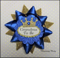 a blue and gold ribbon with a crown on it that says grandma to be in the center