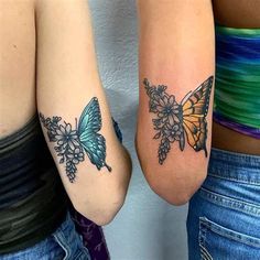 two women with butterfly tattoos on their arms