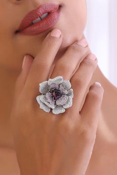 Embrace the enchanting beauty of our Purple Bloom Zirconia Ring. Crafted from brass and adorned with shimmering CZ stones, this ring captures the essence of elegance. Finished in radiant rhodium, its pristine white and vibrant purple hues intertwine, creating a mesmerizing bloom of color. Let this exquisite ring grace your fingers, adding a touch of glamour and sophistication to any ensemble. Embrace the allure of purple bloom and elevate your style with this stunning accessory, destined to spar Elegant Purple Gemstone Flower Ring, Purple Sterling Silver Flower-shaped Jewelry, Chain Braid, Hand Jewelry Rings, Zirconia Rings, Vibrant Purple, Hand Jewelry, Purple Hues, Anklet Jewelry