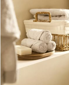 towels and soap on a shelf in a bathroom