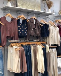 clothes hanging on racks in a clothing store