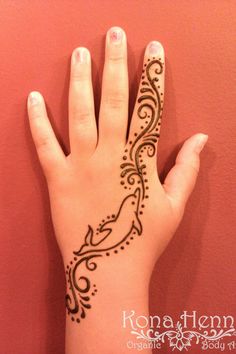 a woman's hand with henna tattoos on her left arm and the wrist