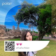 a woman is taking a selfie in front of a tree and some buildings with qr code on it