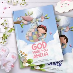 two children's books on a white table with pink flowers and butterflies around them