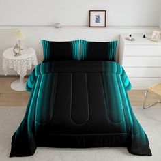 a bed with black and teal comforters in a room