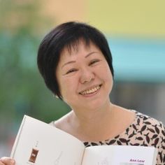 a woman holding an open book in her hands