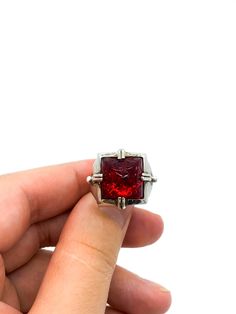 "Vintage Artisan Brutalist Sterling Silver Red Glass Sugarloaf Ring Size 6.75 Up for offer is a unique and stunning vintage artisan made brutalist solid sterling silver and rub red art glass carved sugar loaf paste rhinestone ring. Ring is marked \"925\". Measurements Ring Size: 6.75 Sugarloaf: 13mm x 13mm x 10m Band Width: 5mm Weight: 10.3 g Condition: Excellent; item is pre-owned and may have some signs of light use. Please inspect pictures for overall condition. This item comes from a clean, Red Rectangular Rings With Polished Finish, Red Rectangular Ring With Polished Finish, Rectangular Red Rings With Polished Finish, Modern Red Gemstone Ring, Modern Red Ring Jewelry, Modern Red Rings For Formal Occasions, Modern Red Ring For Formal Occasions, Collectible Red Rings With Polished Finish, Collectible Red Jewelry With Polished Finish