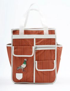 an orange and white tote bag with a bird on it's front pocket