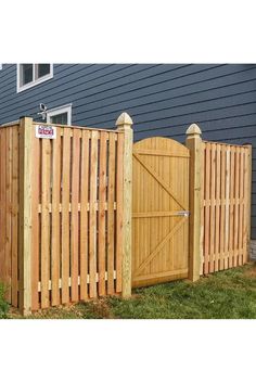 a wooden fence with an open gate