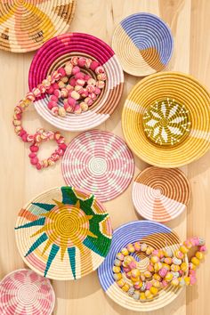 several baskets are arranged on the floor with candy in them