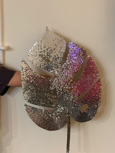 a person standing next to a sculpture made out of sequins