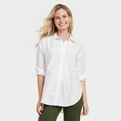 Gear up for your day in smart style in this Oversized Long-Sleeve Collared Button-Down Shirt from Universal Thread™. Made from 100% poplin cotton, this long-sleeve shirt offers all-day breathable comfort. Featuring a collared neckline with a button-front design that adds classic style, this solid button-down shirt features a tunic length with shirttail hem for versatile styling. Universal Thread™: Found exclusively at Target. Button Down Shirt With Leggings, Midi Skirts Style, Fall Workwear, Fall Wardrobe Essentials, Knit Tank Dress, White Collared Shirt, Fitted Tunic, Gingham Shirt, 60 Fashion