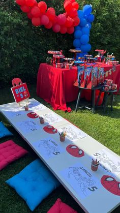 a table set up for a spiderman birthday party