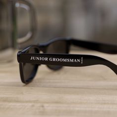 a pair of sunglasses sitting on top of a wooden table