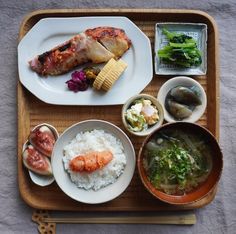 a wooden tray topped with different types of food