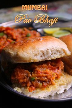 a close up of a plate of food with meats and buns on it