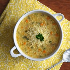 a white bowl filled with soup on top of a yellow napkin