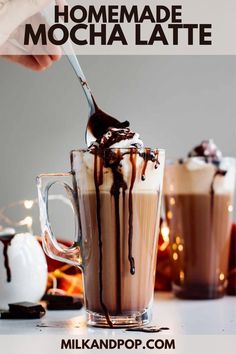 homemade mocha latte in a glass mug with whipped cream and chocolate drizzle