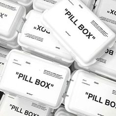 several white plastic containers filled with different types of pillboxes on top of each other