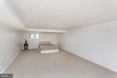 an empty bedroom with white walls and carpeted flooring is pictured in this image