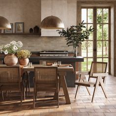 a dining room table surrounded by chairs and potted plants