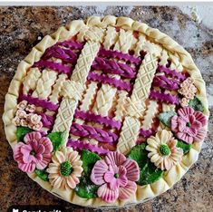 a pie decorated with flowers on top of a table