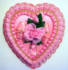 a pink heart shaped paper plate with a rose on the center and gold trimmings