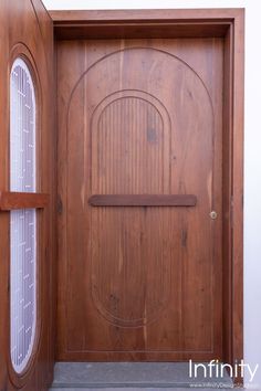 a wooden door with an iron grill on the front and side panels in between it