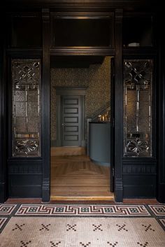 an ornately decorated hallway with black doors