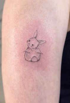 a small rabbit tattoo on the arm