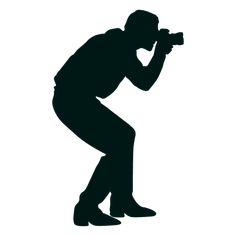 the silhouette of a man with a camera