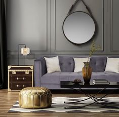 an elegant living room with grey walls and gold accents on the coffee table in front of the couch