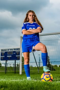 a female soccer player is posing for a photo