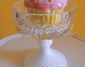 a cupcake sitting on top of a glass plate