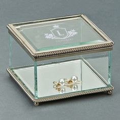 a glass box with two pearls in it