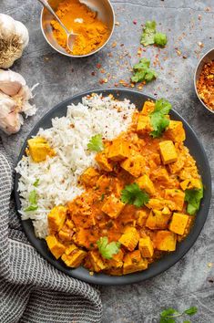 a plate with rice, tofu and spices