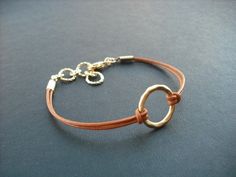 "dainty bracelet made with matte 16K gold plated over brass little hoop and Marigold leather cord bracelet measures total 7.5\" with 1\" extension chain and closed with gold plated lobster clasp hoop measures 15mm diameter bracelet can be made to any length plus 1\" extension chain so you can adjust length, simply leave a note to seller while check out otherwise you'll get 6.5\" plus 1\" extension chain. matching necklace; https://www.etsy.com/listing/62658576/matte-yellow-gold-hoop-pendant-neck Simple Adjustable Small Hoop Jewelry, Adjustable Simple Small Hoop Jewelry, Adjustable Gold Circle Bracelets, Gold Bracelets With Adjustable Waxed Cord, Adjustable Circular Gold Bracelet, Gold Circle Bracelets For Everyday, Gold Waxed Cord Jewelry For Gifts, Adjustable Circular Everyday Jewelry, Adjustable Gold Bracelet With Waxed Cord