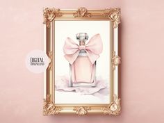 a pink perfume bottle with a bow hanging on a wall next to a gold frame