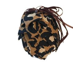 a brown and black animal print bag on a white background with long hair tied to it