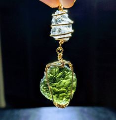 "🌠 GENUINE LARGE 2.6\" MOLDAVITE & Phenacite Necklace Hand Wrapped in 14 kt GOLD!🌠 Beautiful AUTHENTIC Green MOLDAVITE & Phenakite Necklace With GREAT Synergistic Energy! You will receive this exact ONE OF A KIND NECKLACE! The moldavite is from Chlum in the Czech Republic and the LARGE Phenacite is from Brazil! This is a Shine Crystals top selection! It comes with an awesome \"gunmetal\" colored chain (choose your length in the dropdown menu) made in our studio. We are so excited to offer this Green Untreated Collectible Jewelry, Gold Untreated Jewelry As A Gift, Tsavorite Pendant Jewelry As Gift, Green Wire Wrapped Jewelry For Anniversary, Moldavite Pendant, Moldavite Jewelry, Authenticity Certificate, Hand Wrap, Gold Wire