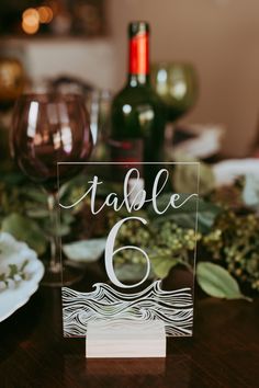 a table number is placed on top of a wooden table