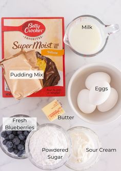 ingredients to make blueberry muffins laid out on a counter