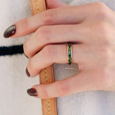 a woman's hand with a ring on her finger